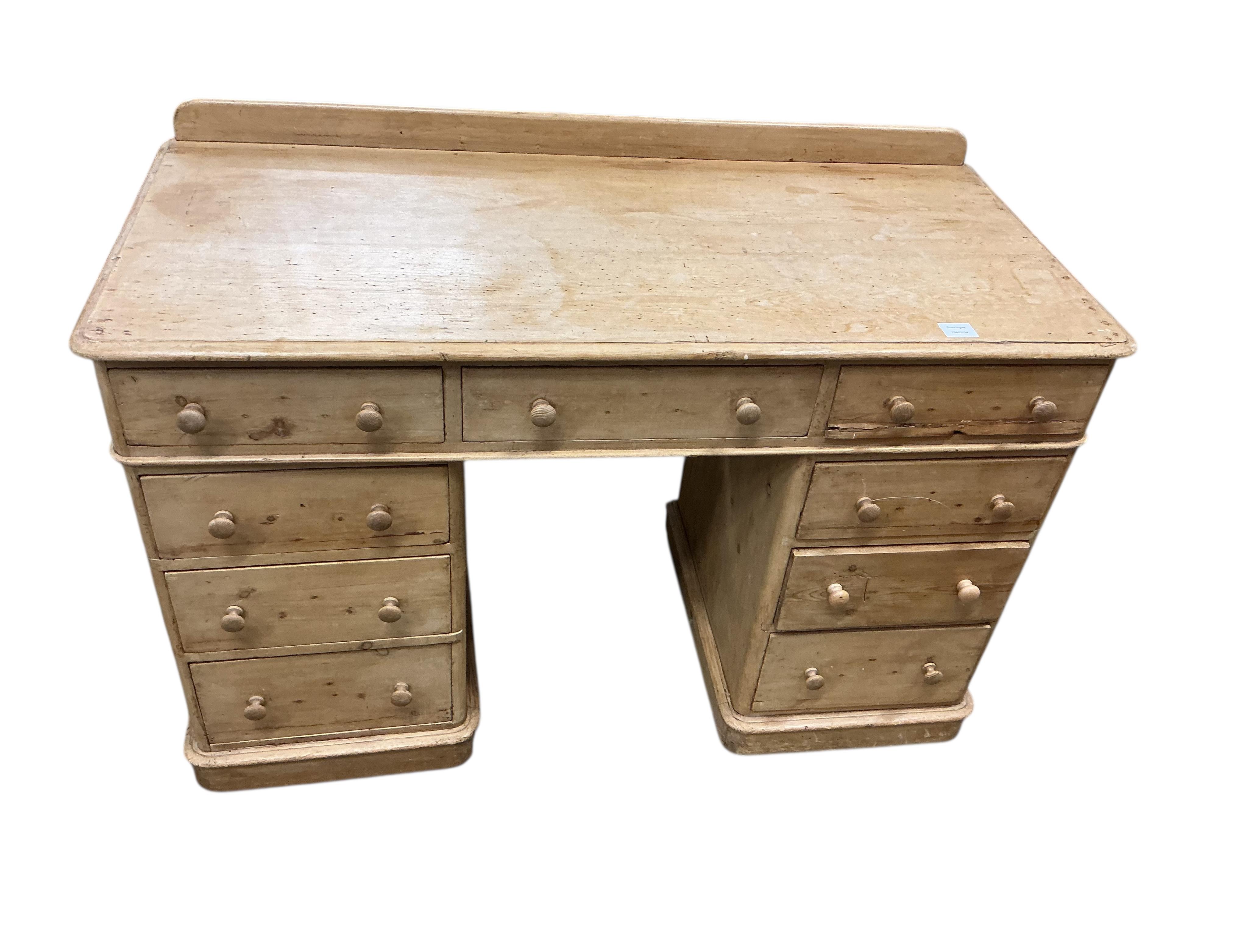 A Victorian pine pedestal desk, fitted with nine small drawers, width 122cm, depth 54cm, height 82cm